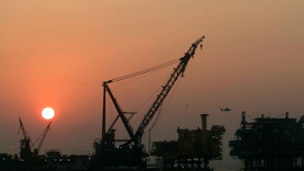 The sun sets behind an Oil & Natural Gas Corp. oil drilling platform at Bombay High, India's biggest offshore oil field, off the coast of Mumbai, India.