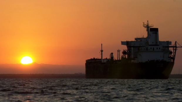 An oil tanker is silhouetted as the sun rises over Lake Maracaibo, Venezuela, on Friday, December 13, 2002. Tanker owners are heading for the second-best year since the 1973 Arab oil embargo, with rising crude-oil demand during the coldest months in the U.S. and Europe set to fuel fourth-quarter profits. Photographer Diego Giudice/Bloomberg News Photographer: DIEGO GIUDICE