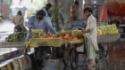 Vendors sell fruits in rain at a market in Rawalpindi, Pakistan, on Friday, July 29, 2022. Pakistan announces its consumer price index (CPI) figures on Aug. 1, 2022.