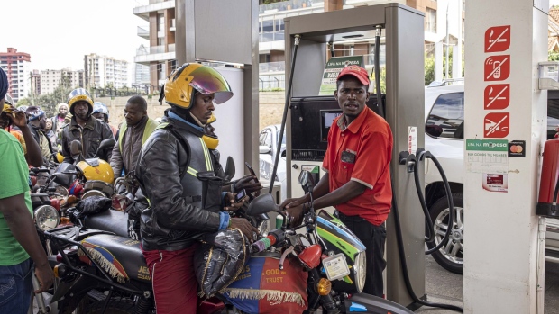 An attendant refuels a motorcycle taxi, also known as a 'boda boda', on the forecourt of a gas station in Nairobi, Kenya, on Wednesday, April 13, 2022. Kenya agreed to compensate oil marketers for selling fuel they imported at rates higher than what’s reflected in the retail cap, a bid to end a supply shortage in the country.