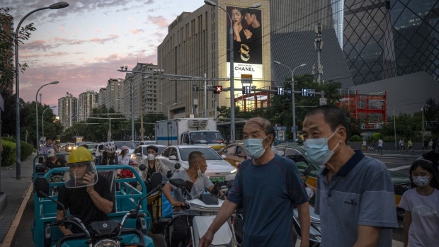 Motorists wait at an intersection in Beijing, China, on Wednesday, Aug. 10, 2022. The UK and China have agreed to resume direct passenger flights, a sign that Chinese authorities are slowly loosening their grip on the world’s tightest Covid-19 regime and opening up to travel again. Bloomberg