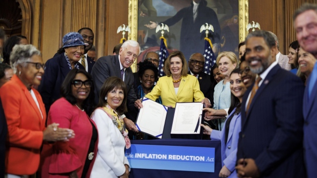 House Speaker Nancy Pelosi holds the bill H.R. 5376, the Inflation Reduction Act of 2022, after signing it at the US Capitol on August 12. 
