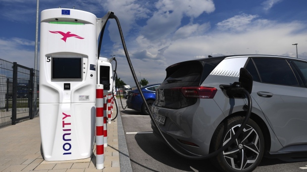 A Volkswagen ID.3 charges beside a Tesla Inc. Model S electric automobile at an Ionity GmbH charging station at motorway service area in Samerberg near Rosenheim, Germany, on Tuesday, June 29, 2021. Royal Dutch Shell Plc and Renault SA are among those interested in taking a stake in Volkswagen-backed electric vehicle charging group Ionity GmbH, Reuters reports, citing two unidentified people familiar with the matter. Photographer: Andreas Gebert/Bloomberg