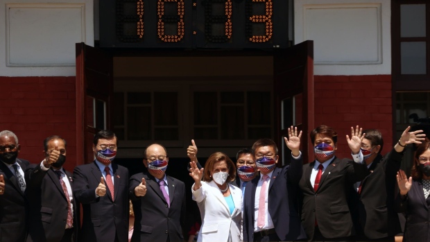Nancy Pelosi waves with lawmakers at the Legislative Yuan in Taipei, Taiwan in Aug 2022. Photographer: I-Hwa Cheng/Bloomberg