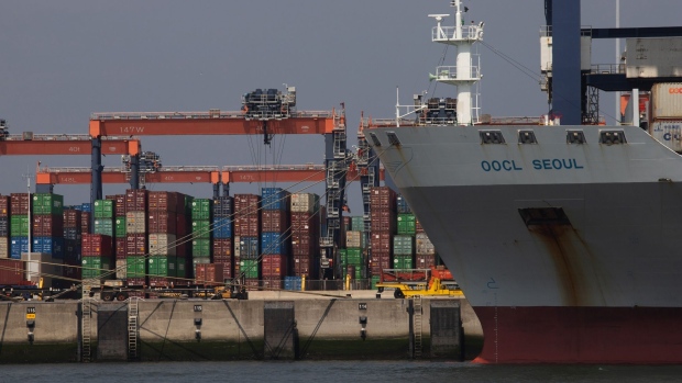 Shipping containers on the dock near cargo ship Seoul, operated by OOCL Logistics Ltd, at the Port of Rotterdam in Rotterdam, Netherlands, on Friday, June 18, 2021. The cost to move goods in a shipping container to Europe from Asia shot above $10,000 for the first time on record, an index showed, underscoring the pain inflicted on exporters and importers struggling with stretched supply chains. Photographer: Peter Boer/Bloomberg