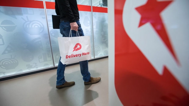 An employee carries a branded paper bag inside the Delivery Hero AG headquarter offices in Berlin, Germany, on Friday, Dec. 8, 2017. Delivery Hero competes with app-based takeout services including Just Eat Plc, GrubHub Inc. and Takeaway.com.