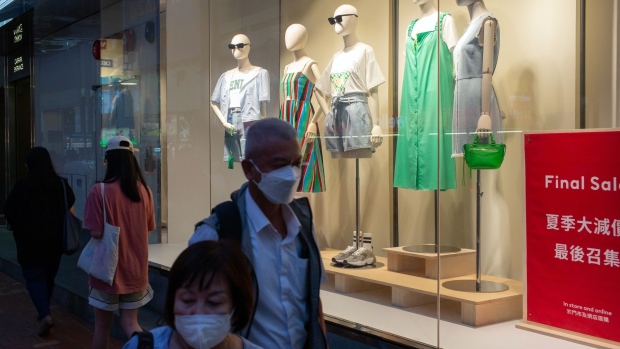 Pedestrians pass mannequins at an Hennes & Mauritz AB (H&M) store in Hong Kong, China, on Sunday, July 31, 2022. Hong Kong is scheduled to release retail sales figures on Aug. 2. Photographer: Billy H.C. Kwok/Bloomberg