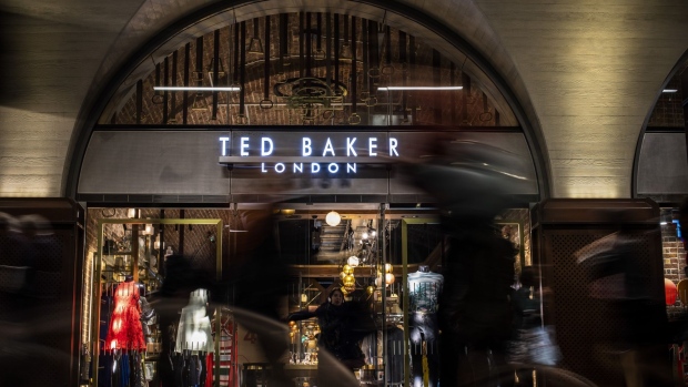Commuters pass a Ted Baker Plc apparel shop in a concourse at London Bridge railway station in London, U.K., on Thursday, June 13, 2019. "My frustration is the government thinking the way to make our country more equal is to make London poorer," London Mayor Sadiq Khan said in an interview Monday.