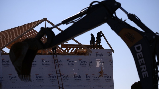 Contractors build the framing of a roof on a house under construction at the Norton Commons subdivision in Louisville, Kentucky, U.S., on Tuesday, Feb. 8, 2022. The U.S. Census Bureau is scheduled to release housing starts figures on Feb. 17.
