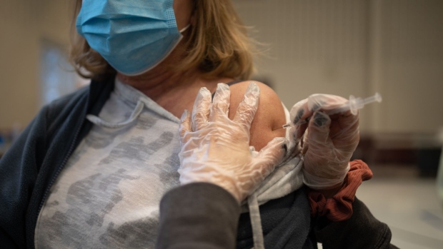 A resident receives a Covid-19 booster shot at a vaccine clinic inside Trinity Evangelic Lutheran Church in Lansdale, Pennsylvania, U.S, on Tuesday, Apr. 5, 2022. U.S. regulators cleared second booster doses of Covid-19 vaccine from Moderna Inc. and the partnership of Pfizer Inc. and BioNTech SE for adults 50 and older, making millions more people eligible for the shots as concern grows about a potential new wave of infections. Photographer: Hannah Beier/Bloomberg