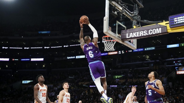  LeBron James of the Los Angeles Lakers dunks against the Atlanta Hawks in the second half at Crypto.com Arena in Los Angeles, in Jan. 2022. 
