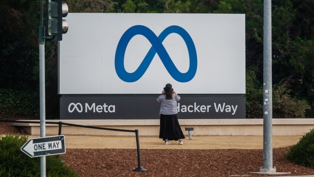 A visitor takes photographs of Meta Platforms signage outside the company's headquarters in Menlo Park, California, U.S., on Friday, Oct. 29, 2021. Facebook Inc. is re-christening itself Meta Platforms Inc., decoupling its corporate identity from the eponymous social network mired in toxic content, and highlighting a shift to an emerging computing platform focused on virtual reality.