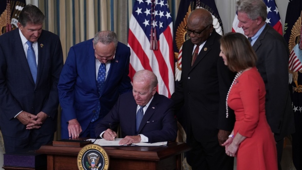 US President Joe Biden signs H.R. 5376, the Inflation Reduction Act of 2022, in the State Dining Room of the White House in Washington, D.C., on Aug. 16. Photographer: Sarah Silbiger/Bloomberg