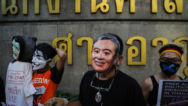 BANGKOK, THAILAND - FEBRUARY 24: A Thai pro-democracy protester wears a face mask portraying former prime minister, Thaksin Shinawatra, on February 24, 2021 in Bangkok, Thailand. Members of the Ratsadon pro-democracy group gather outside the criminal court rally by wearing all black and remaining silent for 112 minutes to symbolize the harsh sentence of Thailand's lese majeste laws. The demonstrators call for the release of political prisoners including those that were recently detained for their involvement in the 2020 protests. (Photo by Lauren DeCicca/Getty Images)