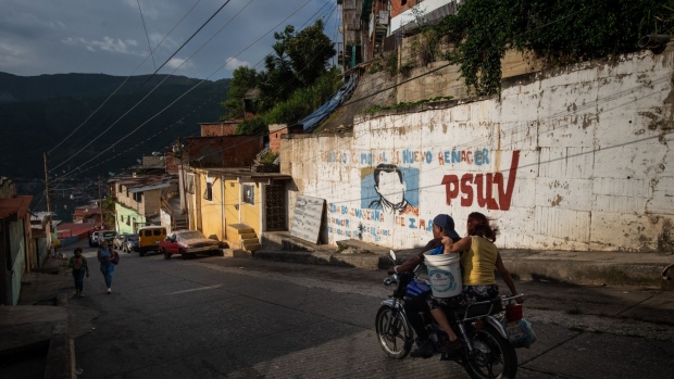 Luis Meza, a retiree, in his house where he collects old Chavez posters. Photographer: Gaby Oraa/Bloomberg