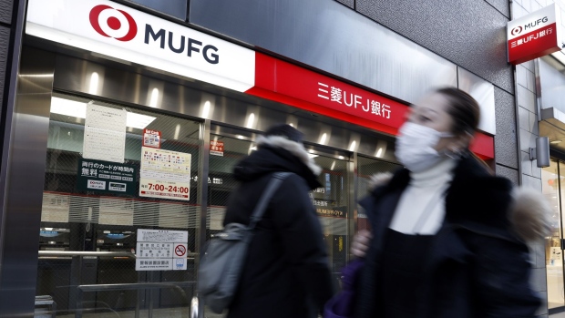 Pedestrians in front of a branch of MUFG Bank Ltd., a unit of Mitsubishi UFJ Financial Group Inc. (MUFG), in Tokyo, Japan, on Monday, Jan. 31, 2022. Mitsubishi UFJ Financial Group is scheduled to release its third-quarter earnings announcement on February 2.