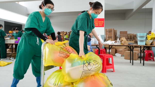Medical workers from Shanghai carry supplies at a COVID-19 makeshift hospital on August 16, 2022 in Sanya, Hainan Province of China. Photographer: Wu Wei/VCG/Getty Images