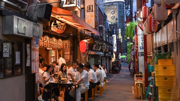 Customers at a bar in the Shinjuku district of Tokyo, Japan, on Thursday, July 29, 2021. While the number of infections directly connected with the Olympics has so far been relatively low, Tokyo and its surrounding areas are experiencing their worst-yet virus wave.