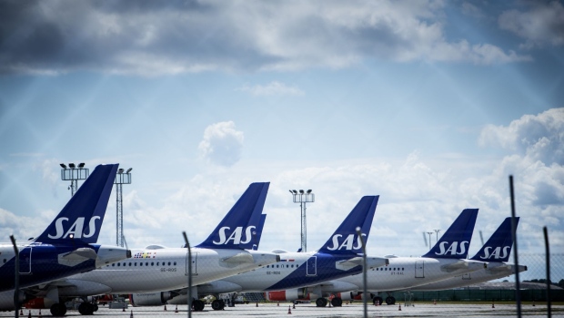Passenger aircraft, operated by SAS AB, on the tarmac at Copenhagen Airport in Copenhagen, Denmark, on Tuesday, July 5, 2022. Scandinavian airline SAS AB filed for Chapter 11 to tackle its debt burden as the recovery from the disruption caused by the coronavirus pandemic has been slower than expected. Photographer: Carsten Snejbjerg/Bloomberg