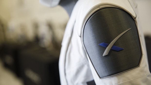 The Space Exploration Technologies Corp. (SpaceX) logo is displayed on a spacesuit ahead of the NASA Commercial Crew Program (CCP) astronaut visit at the SpaceX headquarters in Hawthorne, California, U.S., on Monday, Aug. 13, 2018. Astronauts on SpaceX's Crew Dragon will be the first to fly on an American-made, commercial spacecraft to and from the International Space Station on their mission scheduled for April 2019. Photographer: Patrick T. Fallon/Bloomberg