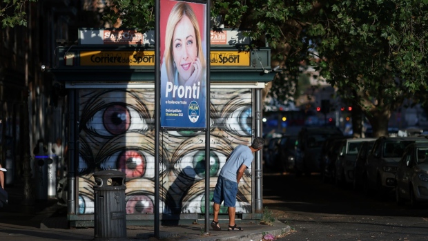 An election poster featuring an image of Giorgia Meloni, leader of the Brothers of Italy party, reading "Ready To Revive Italy", in a residential suburb of Rome, Italy, on Wednesday, Aug. 10, 2022. Italy will hold an early election on Sept. 25.