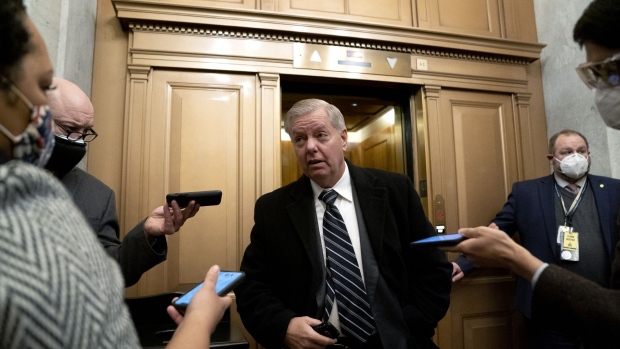 Senator Lindsey Graham, a Republican from South Carolina, center, speaks to members of the media while arriving to the U.S. Capitol in Washington, D.C., U.S., on Saturday, Feb. 13, 2021. The Senate voted to consider a request for witnesses at Donald Trump's impeachment trial, injecting a chaotic new element that could end up prolonging proceedings that appeared to be on track to wrap up today. Photographer: Stefani Reynolds/Bloomberg