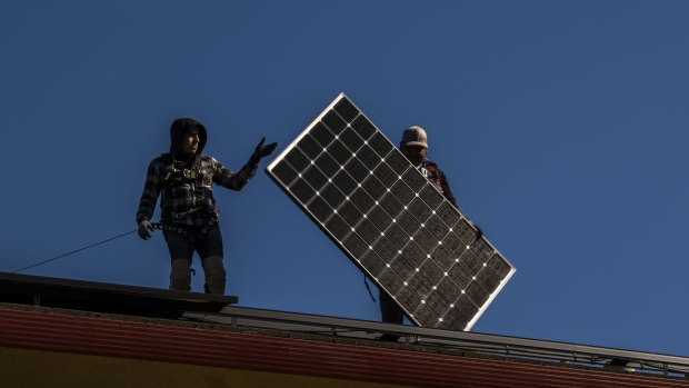 Save A Lot Solar contractors install LG Electronics solar panels on a home in Hayward, California, U.S., on Tuesday, Feb. 8, 2022. California regulators are delaying a vote on a controversial proposal to slash incentives for home solar systems as they consider revamping the measure.