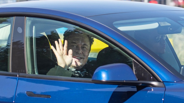 Elon Musk, chief executive officer of Tesla Inc., waves to the media on arrival at the Tesla Inc. Gigafactory construction site in Gruenheide, Germany, on Friday, Aug. 13, 2021. The yet-to-be finished Tesla facility will serve as the backdrop for Armin Laschet's wavering campaign to be Germany’s next chancellor in need of a much-needed boost.