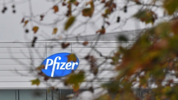 A logo on the Pfizer Inc. facility in Puurs, Belgium, on Thursday, Dec. 3, 2020. The quick approval of Pfizer Inc.’s coronavirus vaccine in the U.K. isn’t likely to accelerate the availability of the shot in Asia, as countries work to complete local safety tests and negotiate deals. Photographer: Geert Vanden Wijngaert/Bloomberg