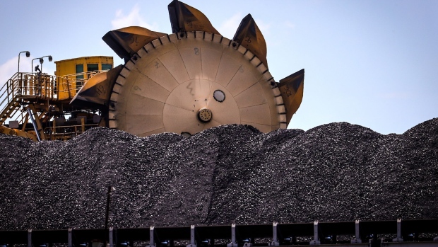 A bucket-wheel reclaimer stands next to a pile of coal at the Port of Newcastle in Newcastle, New South Wales, Australia, on Monday, Oct. 12, 2020. Prime Minister Scott Morrison warned last month that if power generators don't commit to building 1,000 megawatts of gas-fired generation capacity by April to replace a coal plant set to close in 2023, the pro fossil-fuel government would do so itself.