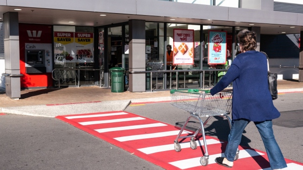 A customer pushes a cart towards a New World supermarket, operated by Foodstuffs New Zealand Ltd., in Wellington, New Zealand, on Wednesday, March 25, 2020. New Zealand declared a state of national emergency, giving the government additional powers to enforce a nationwide lockdown initially in force for four weeks, that will see all schools and non-essential businesses close. Supermarkets, pharmacies and other essential services will remain open, though many are required to limit customers to one at a time.