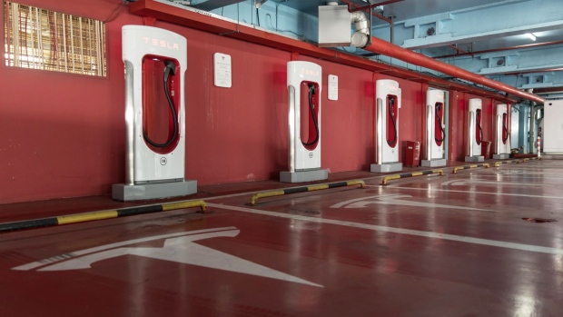Electric vehicle charging stations stand in a Tesla Inc. Supercharger station at a parking garage in Shanghai, China, on Saturday, Nov. 2, 2019. After starting construction this year, Tesla’s new factory is already producing electric vehicles on a trial basis.
