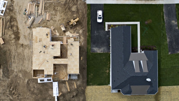 A house under construction stands next to a completed home at the Toll Brothers Inc. Bowes Creek Country Club community in this aerial photograph taken over Elgin, Illinois, U.S., on Wednesday, Sept. 26, 2018. U.S. construction spending inched up 0.1% in August.