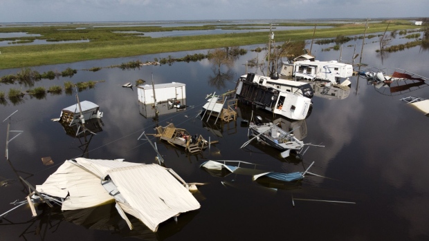 Damaged trailers in floodwater after Hurricane Ida in Pointe-Aux-Chenes, Louisiana, U.S., on Thursday, Sept. 2, 2021. The electric utility that serves New Orleans has restored power to a small section of the city after Hurricane Ida devastated the region's grid. Photographer: Mark Felix/Bloomberg
