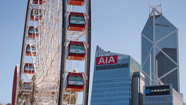 The AIA Central building, which houses the headquarters of AIA Group Ltd., center, next to the Bank of China Tower, rear right, and CCB Tower, in Hong Kong, China, on Wednesday, March 9, 2022. AIA is scheduled to release earnings results on March 11. Photographer: Bertha Wang/Bloomberg