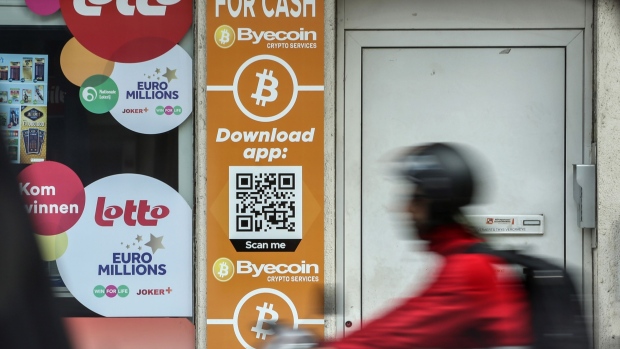 Bitcoin and the Byecoin app are advertised in the window of a store in Antwerp, Belgium, on Monday, June 6, 2022. Bitcoin has been trading around the $30,000 level for weeks now, defying predictions of a potential further decline but also struggling to gain upward momentum as the broader US market has also taken a beating. Photographer: Valeria Mongelli/Bloomberg