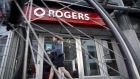 A pedestrian passes in front of a Rogers Communications Inc. store in Toronto, Ontario, Canada, on Wednesday, May 17, 2017. Rogers Communications, Canada's largest wireless carrier, is leveraging organic growth in the country's wireless market to expand its subscriber base. Photographer: Brent Lewin/Bloomberg