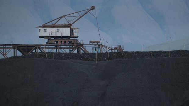 LONGYEARBYEN, NORWAY - JULY 29: Machinery once used for loading coal from local mines onto ships stands over a pile of coal from the last remaining nearby operational mine on Svalbard archipelago on July 29, 2020 in Longyearbyen, Norway. Svalbard archipelago, which lies approximately 1,200km north of the Arctic Circle, is currently experiencing a summer heat wave that set a new record in Longyearbyen on July 25 with a high of 21.7 degrees Celsius. Global warming is having a dramatic impact on Svalbard that, according to Norwegian meteorological data, includes a rise in average winter temperatures of 10 degrees Celsius over the past 30 years, creating disruptions to the entire local ecosystem. Longearbyen was founded in 1906 by American businessman John Munro Longyear, who founded the town's coal industry that became its main economic pillar until the late 20th century. (Photo by Sean Gallup/Getty Images)
