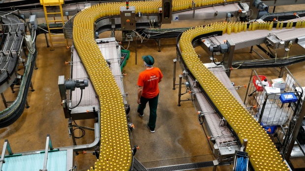 A worker walks between orange flavoured drinks on the production line at the Refresco soft-drink bottling factory in Kegworth, U.K., on Tuesday, Oct. 5, 2021. PAI Partners is considering options for Refresco, including a possible initial public offering that could value the bottling business at about $6 billion, according to people familiar with the matter.