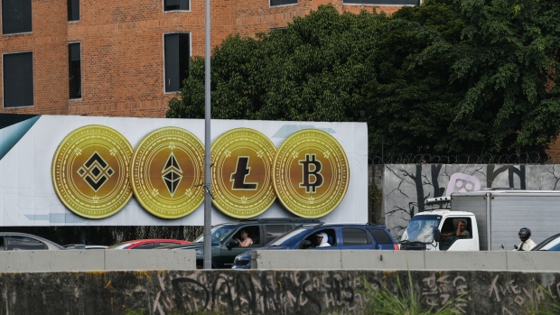 A billboard displaying the tokens of Binance, from left, Ethereum, Litecoin and Bitcoin cryptocurrencies in Caracas, Venezuela, on Tuesday, Feb. 1, 2022. In January, the Venezuelan National Assembly accepted for consideration a bill to establish provisions for digital currency transactions. Photographer: Carolina Cabral/Bloomberg