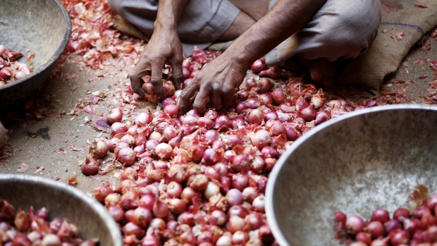 India will import 1,000 metric tons of onions and kept a ban on export of edible oils and lentils to cool prices, ahead of a report today that may show inflation accelerated last month.