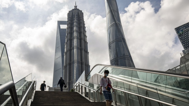 Pedestrians in Pudong's Lujiazui Financial District in Shanghai, China, on Monday, June 20, 2022. Shanghai’s weekend Covid-testing blitz found the virus seemingly contained, after a spike in cases last week had fanned concern the city would be plunged back into lockdown. Photographer: Qilai Shen/Bloomberg