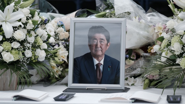 A photograph of former Prime Minister Shinzo Abe at a makeshift memorial at the Liberal Democratic Party (LDP) headquarters in Tokyo, Japan, on Monday, July 11, 2022. The death of Shinzo Abe, Japans longest serving premier, after being shot at a campaign event last Friday, has left the nation shocked and grieving.