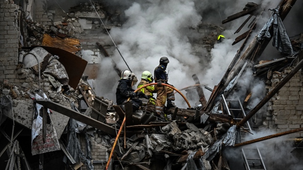 Firefighters extinguish a fire after an apartment was hit by a missile strike in Kharkiv, on September 6. Photographer: Sergey Bobok/AFP/Getty Images