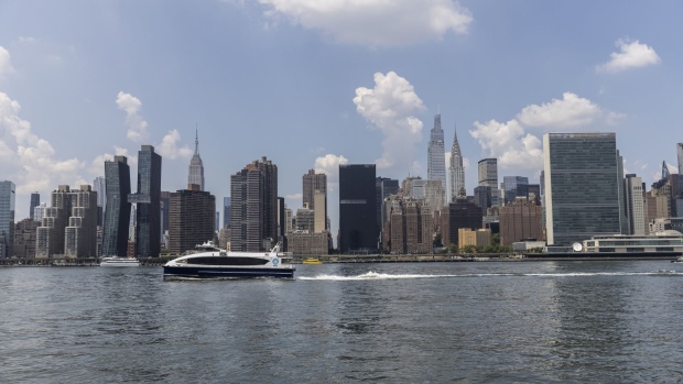 A NYC Ferry travels on the East River during a heat wave in New York, US, on Wednesday, July 20, 2022. With temperatures rising into the 90s Fahrenheit, New York City and the Northeast heading into its longest heat wave of the summer. Photographer: Victor J. Blue/Bloomberg