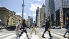 Pedestrians in downtown Toronto, Ontario, Canada, on Friday, June 17, 2022. In his eight years as chief executive officer of CIBC, Victor Dodig has turned the lender into one of the country's fastest-growing banks. His next task is convincing investors the change will stick.