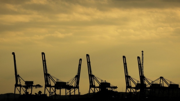 Gantry cranes are silhouetted at a shipping terminal in Yokohama, Japan, on Monday, Dec. 14, 2020. Japan is scheduled to release trade balance figures on Dec. 16. Photographer: Kiyoshi Ota/Bloomberg