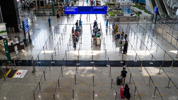 Travelers heading to quarantine in the arrival hall at Hong Kong International Airport in Hong Kong.