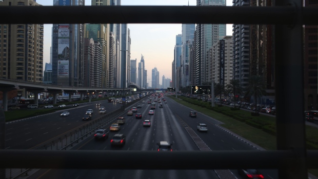 Evening traffic passes along the Sheikh Zayed highway past city skyscrapers in Dubai, United Arab Emirates, on Friday, Nov. 6, 2015.  Photographer: Jasper Juinen/Bloomberg