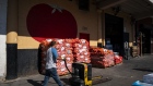 A worker at a wholesale produce market in the Union Market district in Washington, D.C.. Photographer: Al Drago/Bloomberg